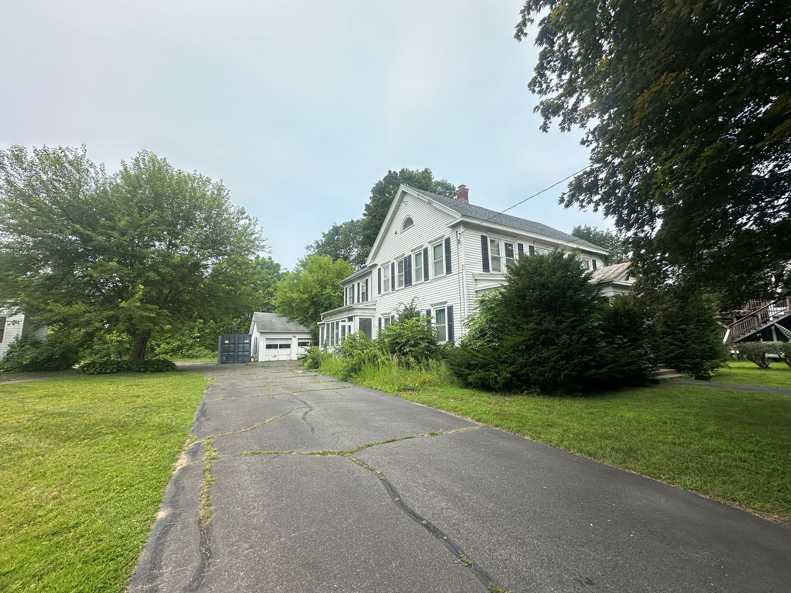View of the rectory building and garage from the entrance drive. View of the rectory building and garage from the entrance drive.